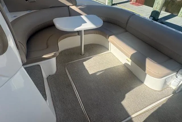 Slide: The Image of 2001 Cruisers Yachts 3672 Express interior with curved seating and table. - 6
