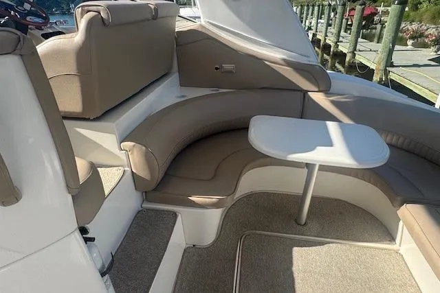 Slide: The Image of 2001 Cruisers Yachts 3672 Express interior with beige seating and table. - 8