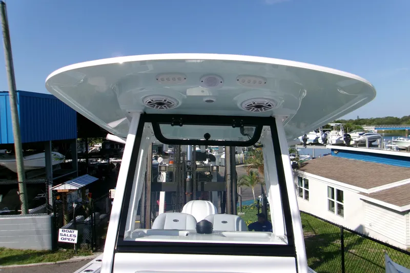 Slide: The Image of 2026 Sportsman Heritage 231 Center Console boat at a marina, showcasing its helm and T-top. - 12