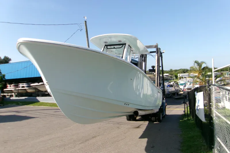 Slide: The Image of 2026 Sportsman Heritage 231 Center Console boat on a trailer at a marina. - 3