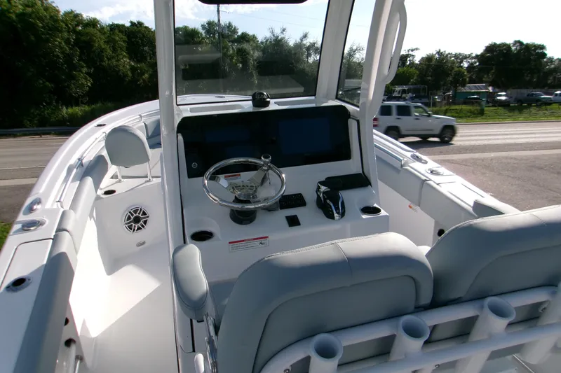 Slide: The Image of 2026 Sportsman Heritage 231 Center Console boat interior with steering wheel and seating. - 5