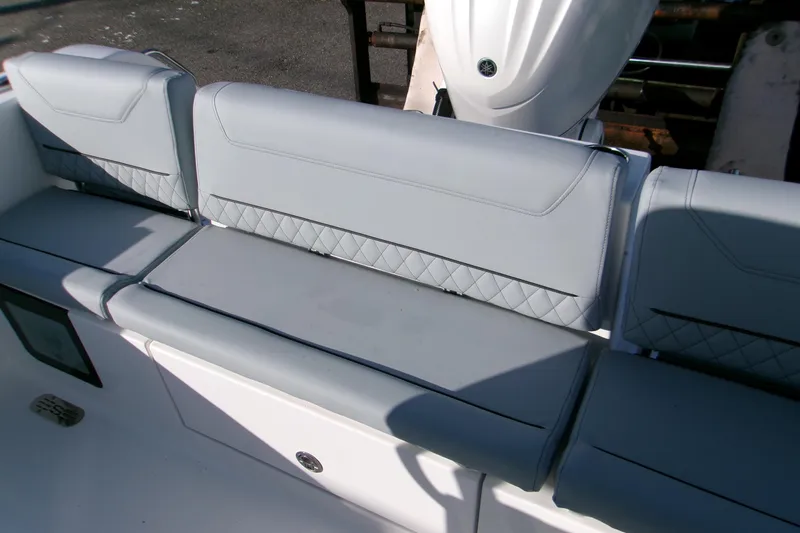 Slide: The Image of 2026 Sportsman Heritage 231 Center Console boat seating with gray upholstery and diamond stitching. - 6