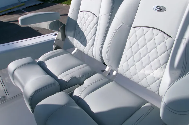 Slide: The Image of 2026 Sportsman Heritage 231 Center Console boat seats with quilted design and armrest. - 7