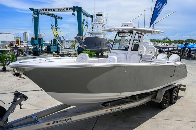 Slide: The Image of 2026 Sportsman Open 262 Center Console boat on trailer at marina. - 1