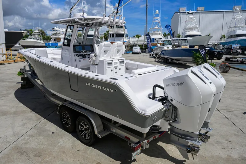 Slide: The Image of 2026 Sportsman Open 262 Center Console boat with dual Mercury engines on a trailer. - 2