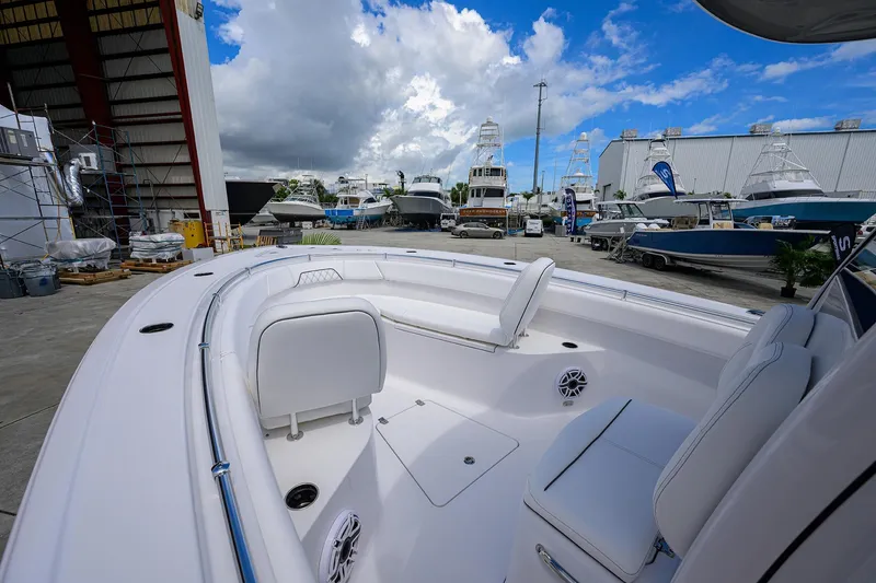 Slide: The Image of 2026 Sportsman Open 262 Center Console boat in a marina with clear skies. - 6