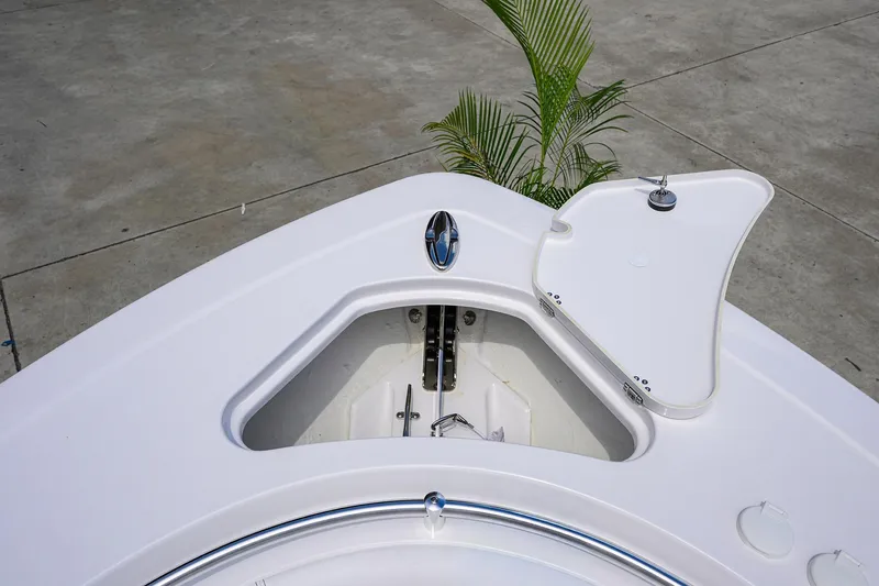 Slide: The Image of 2026 Sportsman Open 262 Center Console boat anchor compartment, open lid, dockside view. - 8
