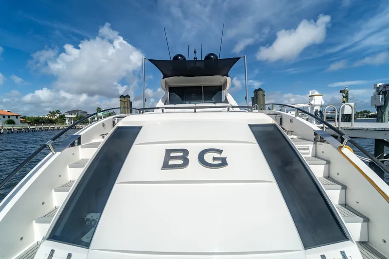 Slide: The Image of 2009 Lazzara LSX 75 yacht docked, featuring sleek design and spacious deck. - 11