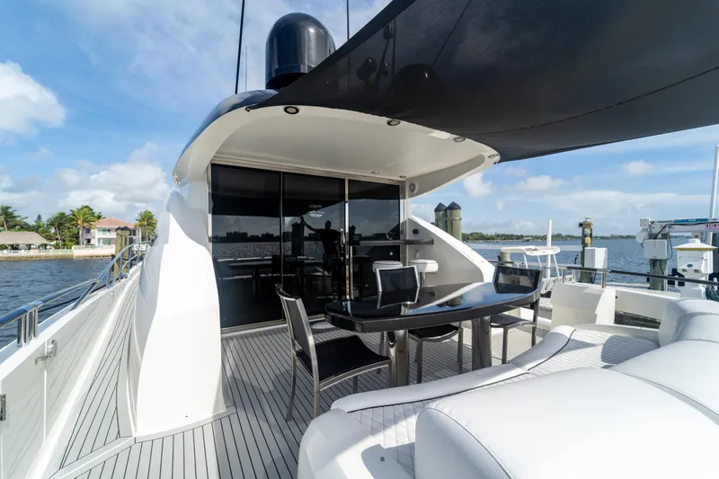 Slide: The Image of Luxurious 2009 Lazzara LSX 75 yacht deck with modern seating and dining area. - 12