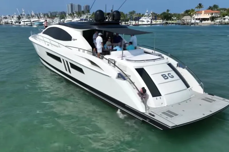 Slide: The Image of 2009 Lazzara LSX 75 yacht cruising in clear blue waters, with people on deck. - 2