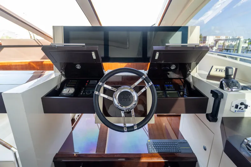 Slide: The Image of 2009 Lazzara LSX 75 yacht helm with modern controls and sleek steering wheel. - 34