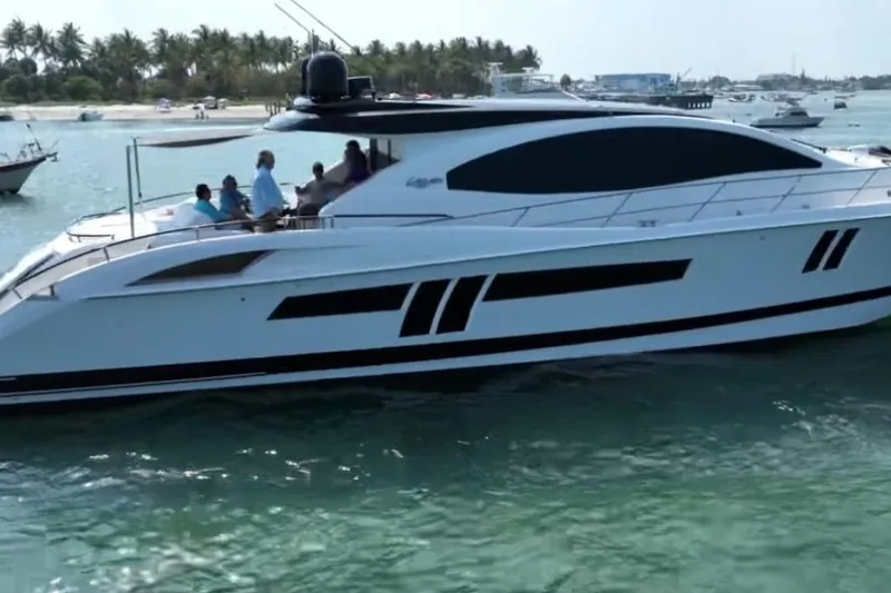 Slide: The Image of 2009 Lazzara LSX 75 yacht cruising on clear waters with passengers onboard. - 5