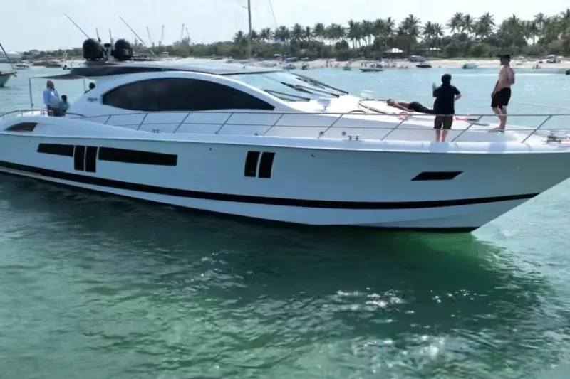 Slide: The Image of 2009 Lazzara LSX 75 yacht cruising in clear waters with people on deck. - 6