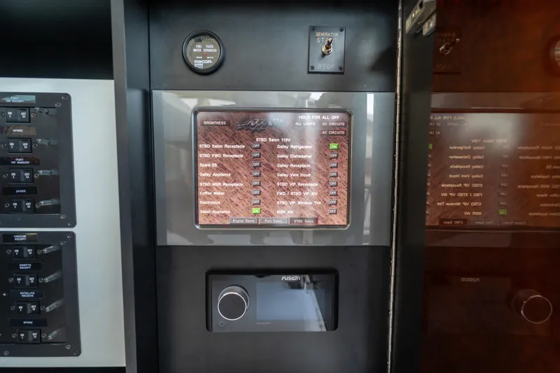 Slide: The Image of Control panel of a 2009 Lazzara LSX 75 yacht with various switches and displays. - 62