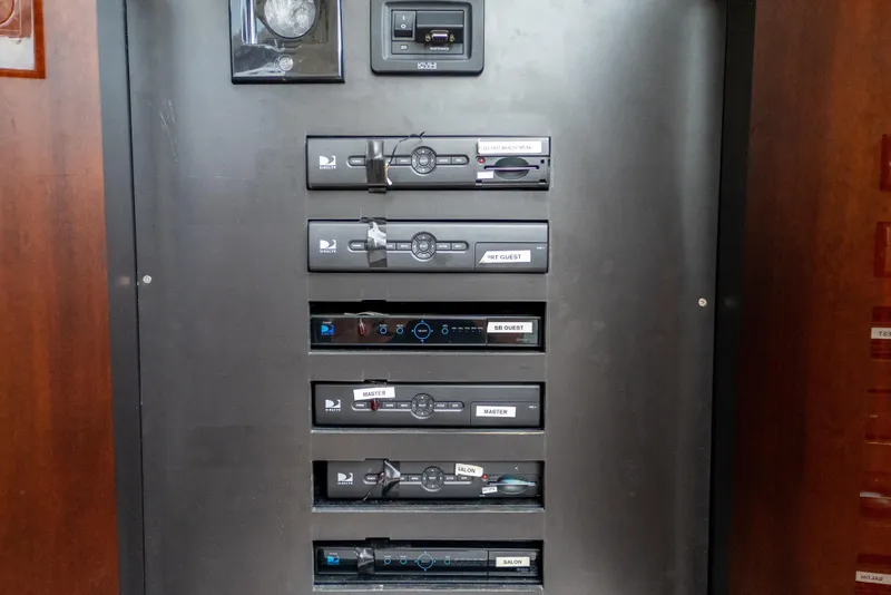 Slide: The Image of Control panel on 2009 Lazzara LSX 75 yacht with labeled switches and devices. - 64