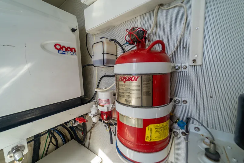 Slide: The Image of Engine room of 2009 Lazzara LSX 75 yacht with fire extinguisher and Onan generator. - 75