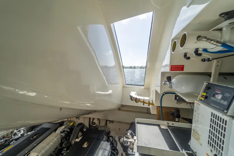 Slide: The Image of Engine room of 2009 Lazzara LSX 75 yacht with view of water through windows. - 76