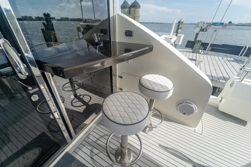 Slide: The Image of Luxury yacht Lazzara LSX 75 (2009) with elegant bar stools and waterfront view. - 8