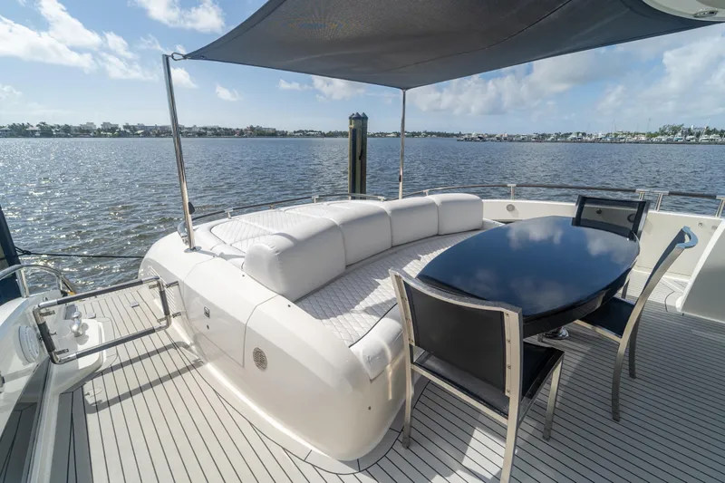 Slide: The Image of Luxurious 2009 Lazzara LSX 75 yacht deck with elegant seating and dining area. - 9