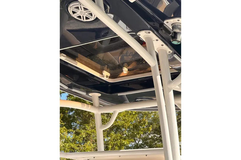 Slide: The Image of 2018 Sportsman Open 252 Center Console boat's T-top structure and speaker detail. - 4