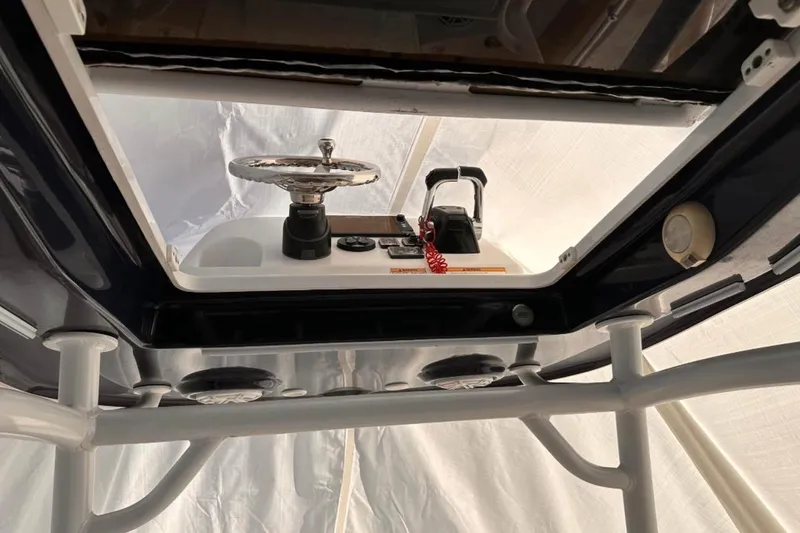 Slide: The Image of 2018 Sportsman Open 252 Center Console helm view with steering wheel and controls. - 5