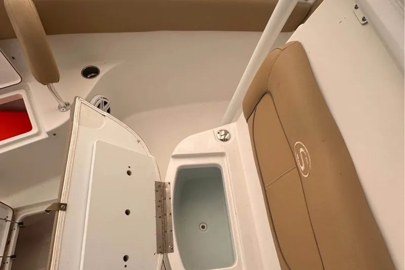 Slide: The Image of 2018 Sportsman Open 252 Center Console interior with tan seating and storage compartments. - 7