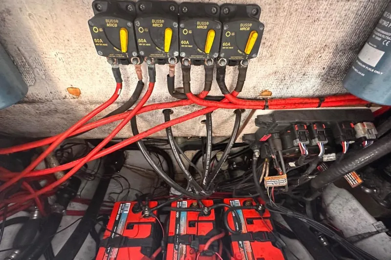 Slide: The Image of Electrical wiring and circuit breakers in a 2018 Sportsman Open 252 Center Console boat. - 9