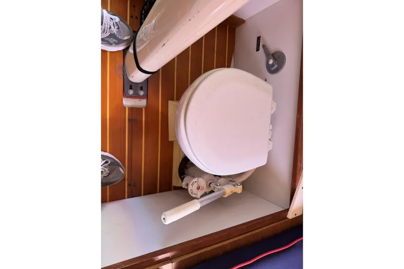 Slide: The Image of 2006 Alerion Express 28 sailboat interior with marine toilet and wooden flooring. - 15