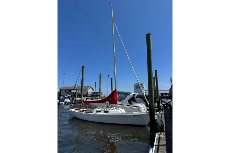 Slide: The Image of Alerion Express 28 sailboat docked at a marina, 2006 model, under clear blue sky. - 18
