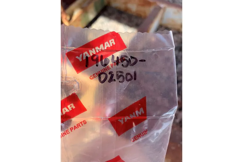 Slide: The Image of Clear plastic bag with Yanmar genuine parts label and handwritten numbers. - 8