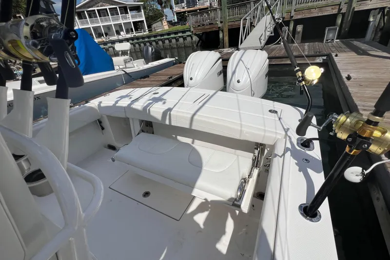 Slide: The Image of 2025 Regulator 28 boat with fishing rods and twin Yamaha engines at dock. - 11