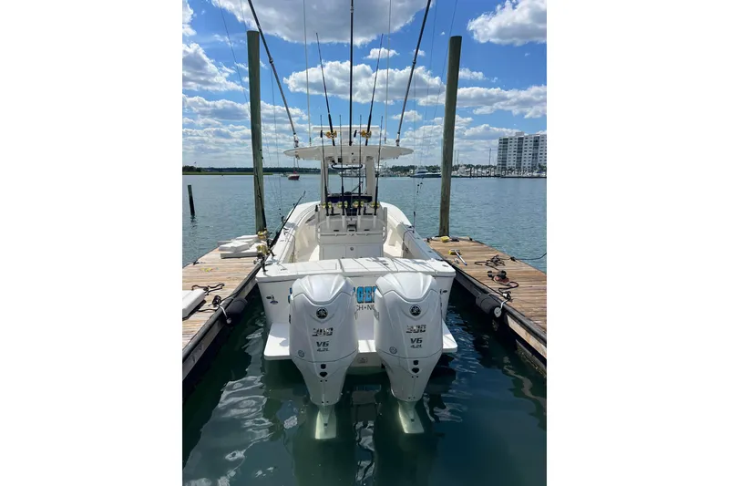Slide: The Image of 2025 Regulator 28 boat docked, featuring dual outboard engines under a clear sky. - 13