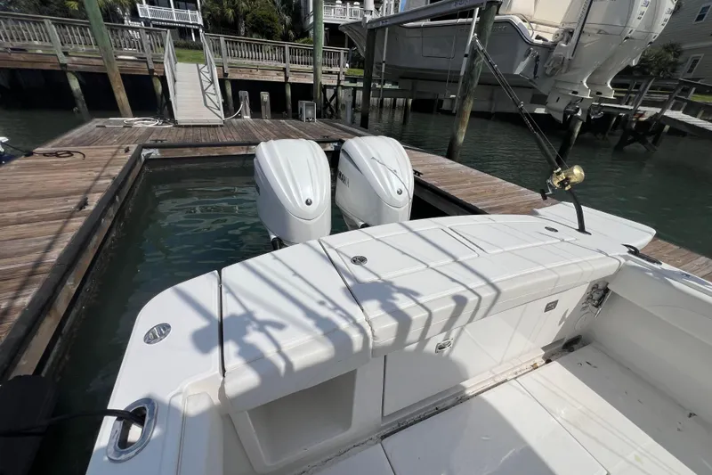 Slide: The Image of 2025 Regulator 28 boat docked, featuring dual outboard engines and fishing rod setup. - 3