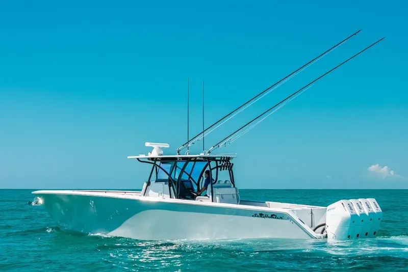 Slide: The Image of 2024 SeaHunter 39 Tournament boat cruising on clear blue ocean waters. - 1