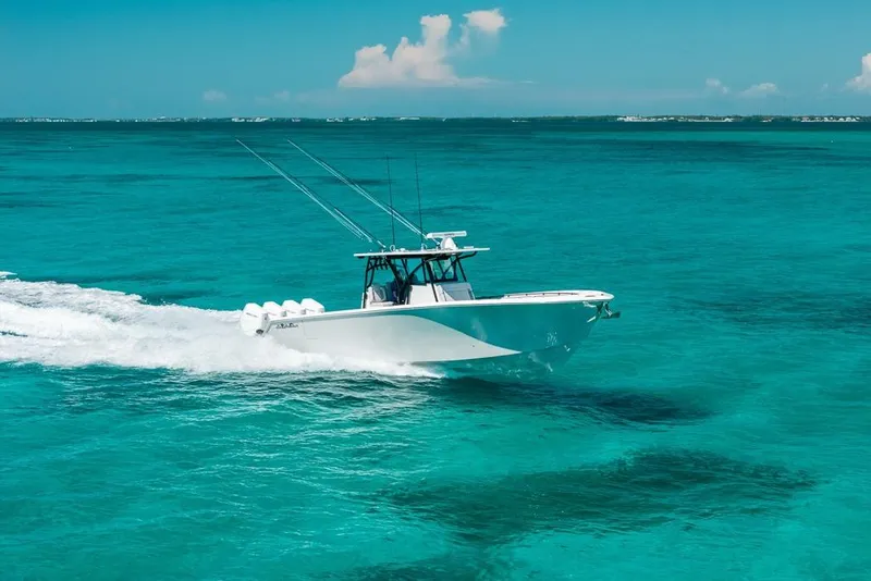 Slide: The Image of 2024 SeaHunter 39 Tournament boat cruising on clear turquoise waters. - 10