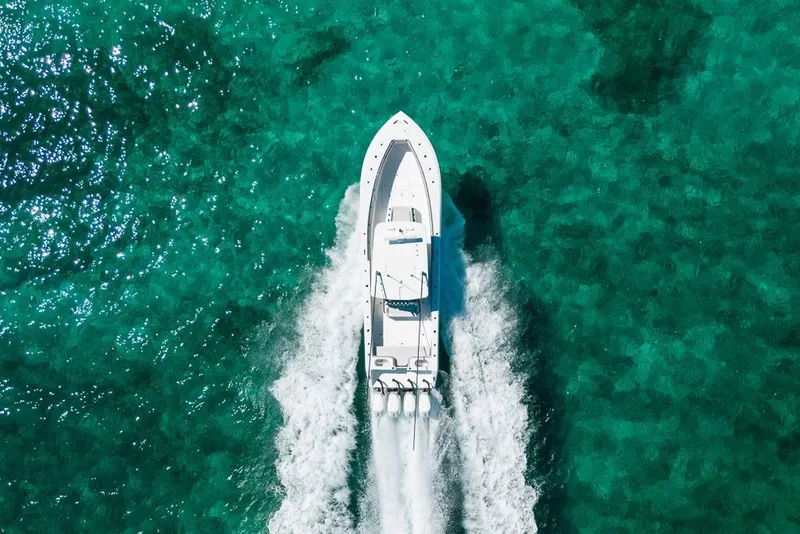 Slide: The Image of Aerial view of 2024 SeaHunter 39 Tournament boat cruising on clear turquoise water. - 11