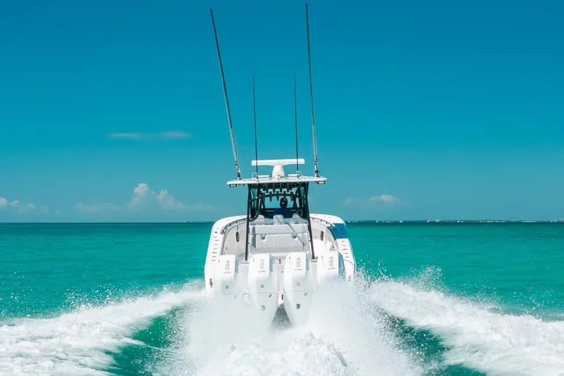 Slide: The Image of 2024 SeaHunter 39 Tournament boat cruising on turquoise ocean waters. - 15