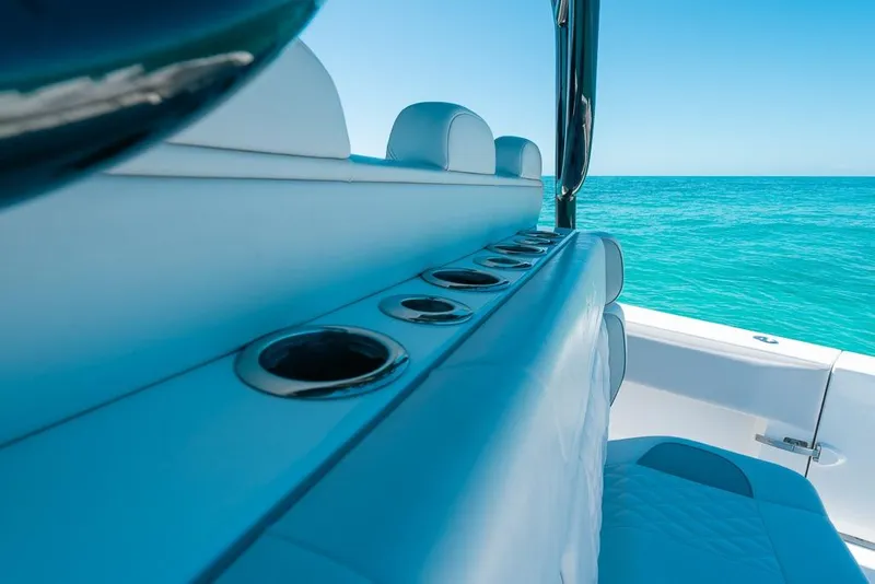 Slide: The Image of 2024 SeaHunter 39 Tournament boat interior with ocean view, featuring rod holders. - 21