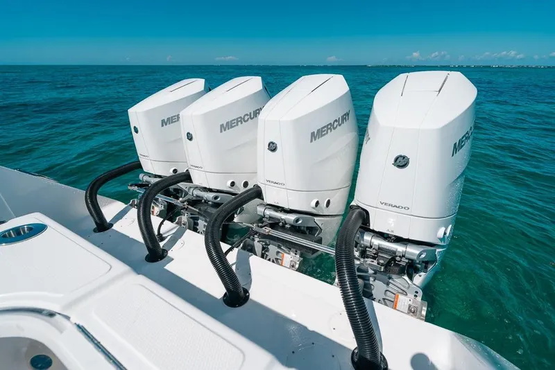 Slide: The Image of Four Mercury Verado outboard engines on 2024 SeaHunter 39 Tournament boat in clear blue water. - 27