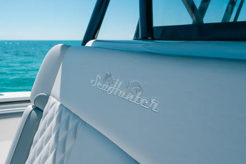 Slide: The Image of 2024 SeaHunter 39 Tournament boat interior with logo, ocean view in background. - 39