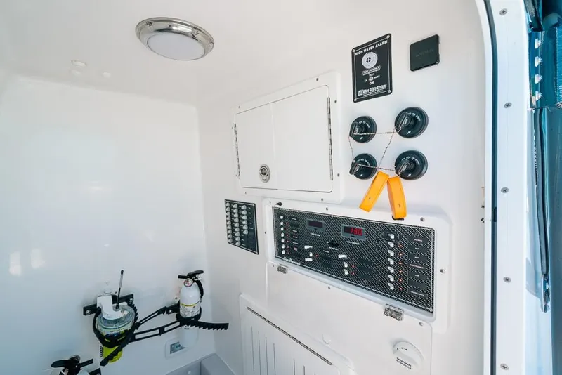 Slide: The Image of 2024 SeaHunter 39 Tournament control panel with switches and safety equipment. - 42