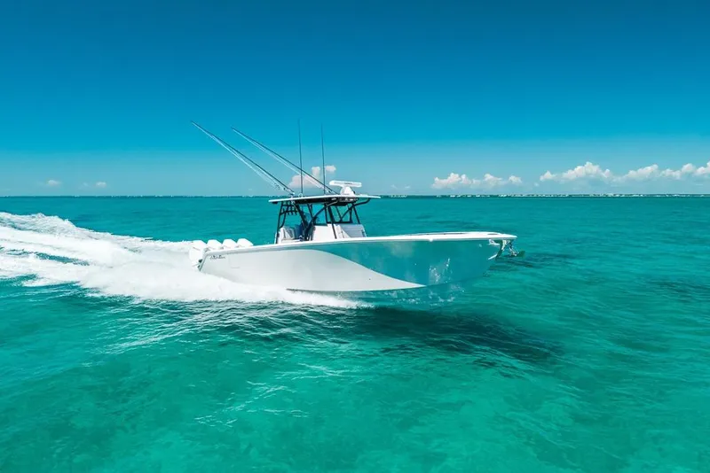 Slide: The Image of 2024 SeaHunter 39 Tournament boat cruising on clear turquoise waters. - 9