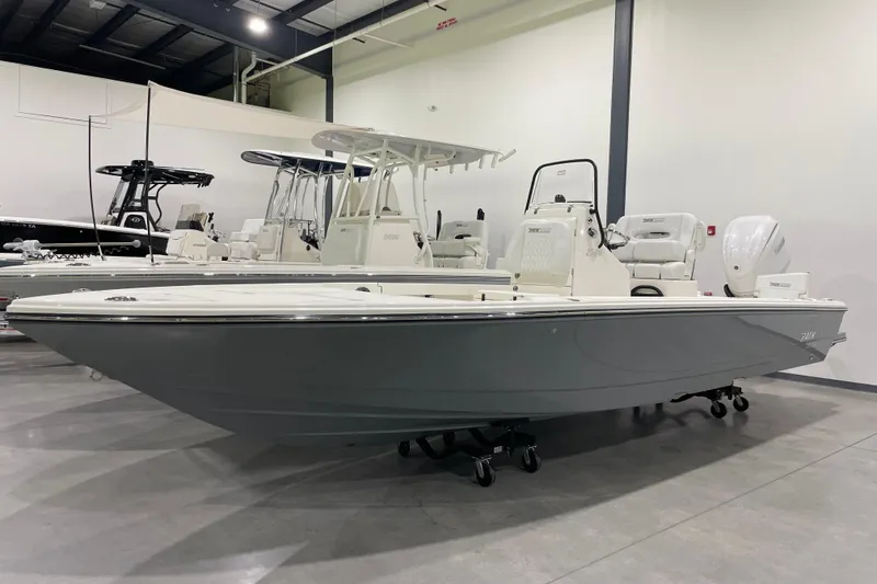 The Image of 2026 Pathfinder 2500 Hybrid boat in showroom, sleek design, white and gray color scheme. - 0
