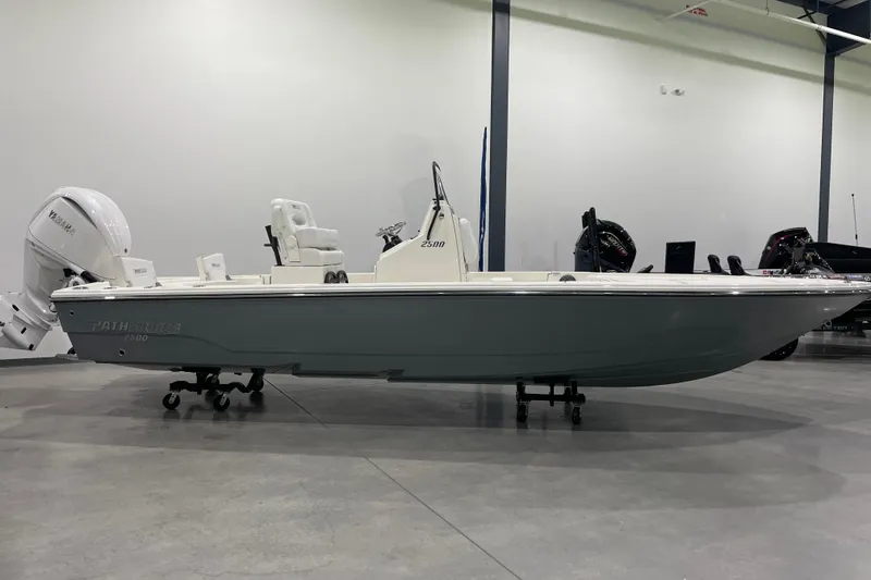 Slide: The Image of 2026 Pathfinder 2500 Hybrid boat in showroom, side view with Yamaha engine. - 10