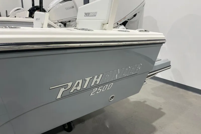 Slide: The Image of 2026 Pathfinder 2500 Hybrid boat, gray exterior, displayed indoors. - 3