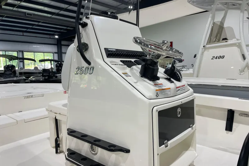 Slide: The Image of 2026 Pathfinder 2500 Hybrid boat console in showroom, featuring sleek design and controls. - 6