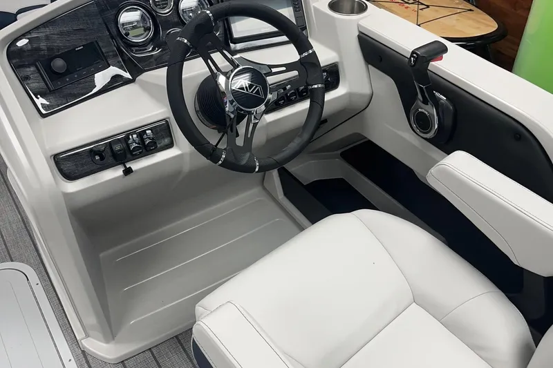 Slide: The Image of 2026 Avalon 25 LSZ Versatile Rear Lounger boat cockpit with steering wheel and controls. - 3