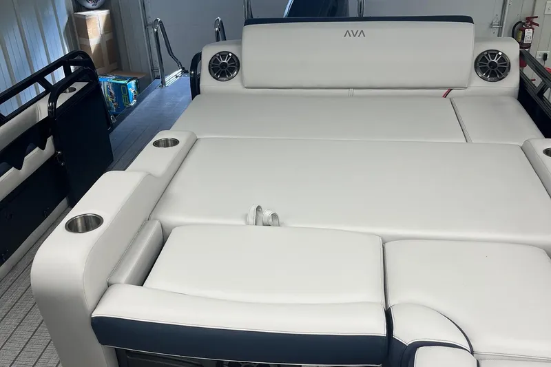 Slide: The Image of 2026 Avalon 25 LSZ Versatile Rear Lounger with white cushioned seating and cup holders. - 5