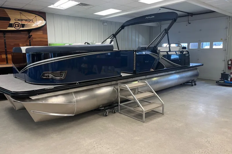 Slide: The Image of 2026 Avalon 25 LSZ Versatile Rear Lounger pontoon boat in showroom with sleek design. - 8