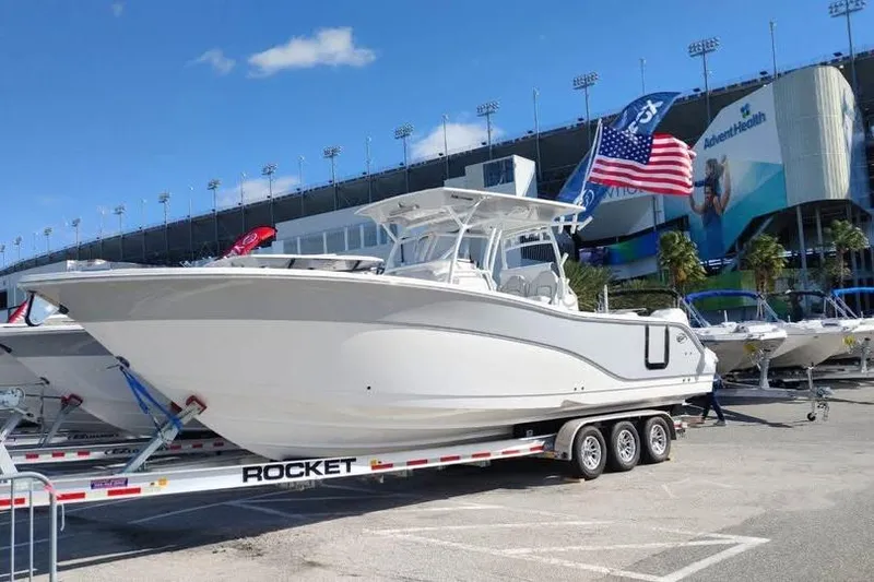 The Image of 2023 Sea Fox 328 Commander boat on trailer, displayed outdoors with American flag. - 1